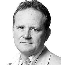 Black and white headshot of a middle-aged man with short hair, wearing a collared shirt and jacket.