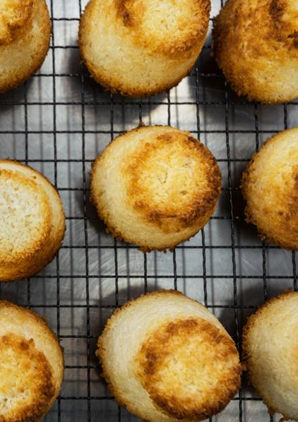 Overhead view of freshly baked macaroons cooling on a wire rack.