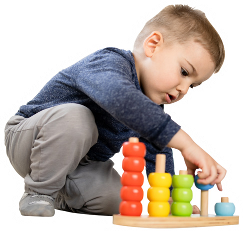 A young child playing with a colorful wooden ring-stacking and sorting toy.
