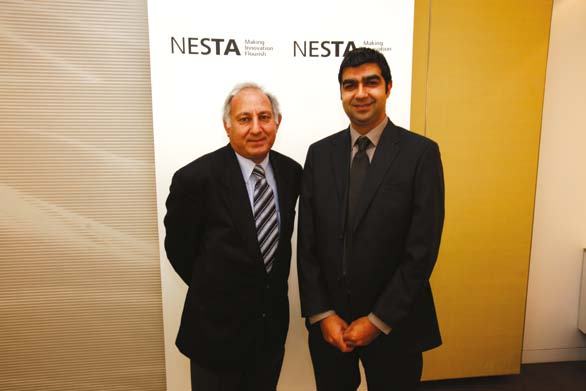 Two men standing in front of a NESTA banner with the slogan "Making Innovation Flourish".