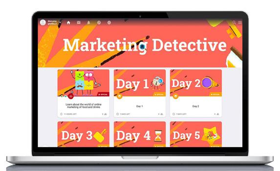 Laptop screen displaying an online course interface titled "Marketing Detective" with modules like "Day 1" and "Day 2."