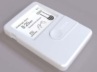 Product photo of a white Kudos electronic device displaying 'challenge starts 8:20 am', 'Reward level: Bronze', '£52 yesterday', and a progress bar towards £5000.