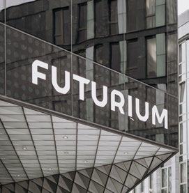 Close-up of a modern building facade with "FUTURIUM" prominently displayed in white lettering.