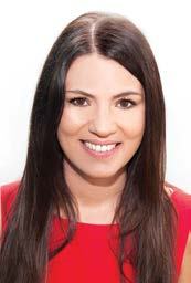 Headshot of a smiling woman with long dark hair, wearing a red top.