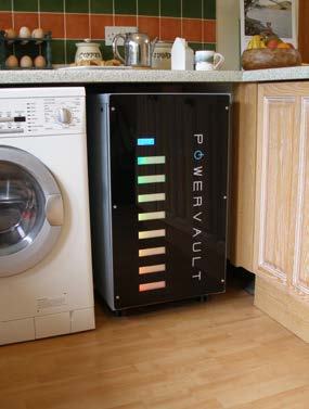 PowerVault energy storage unit with colored indicator lights, installed in a kitchen next to a washing machine and under a counter.