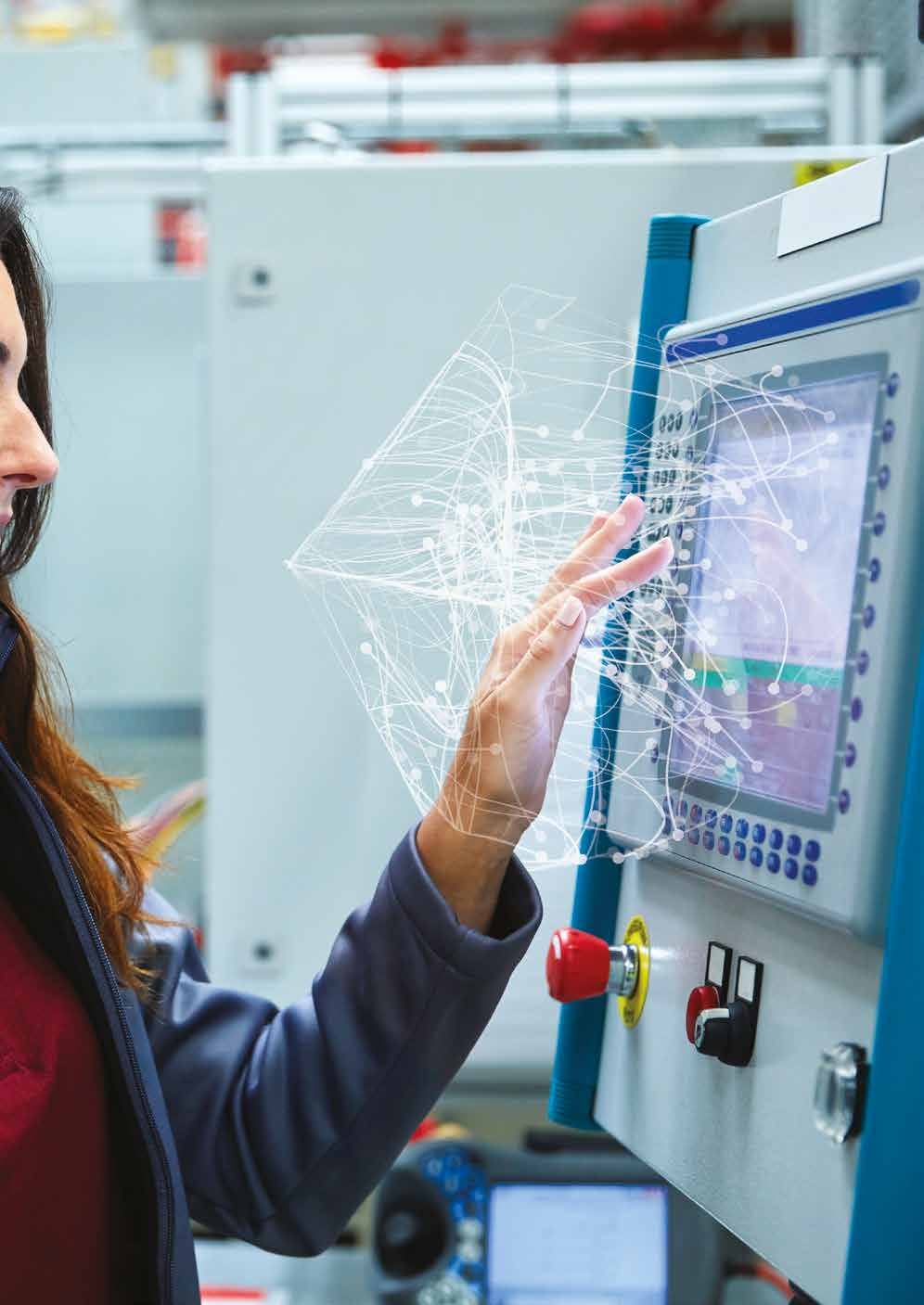 Woman's hand interacting with a machine control panel, with a glowing network of data points projected around her hand and the screen.