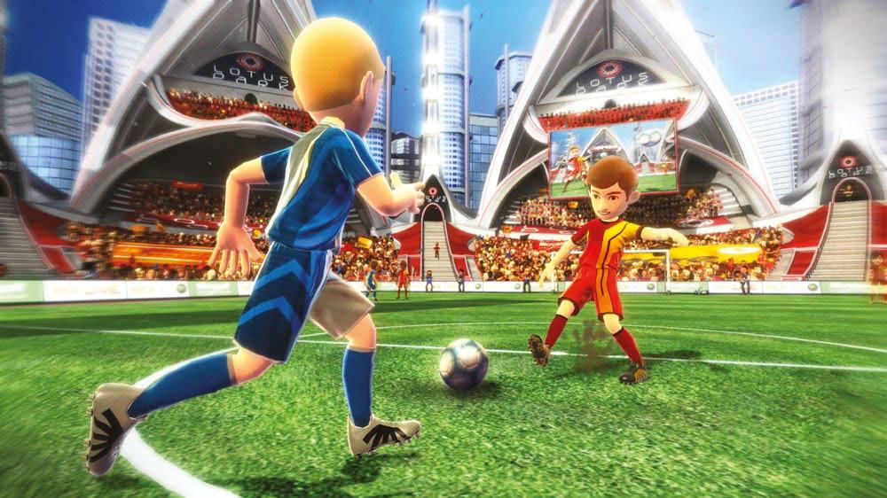 Screenshot from a video game showing two animated soccer players on a green field in a large, modern stadium.