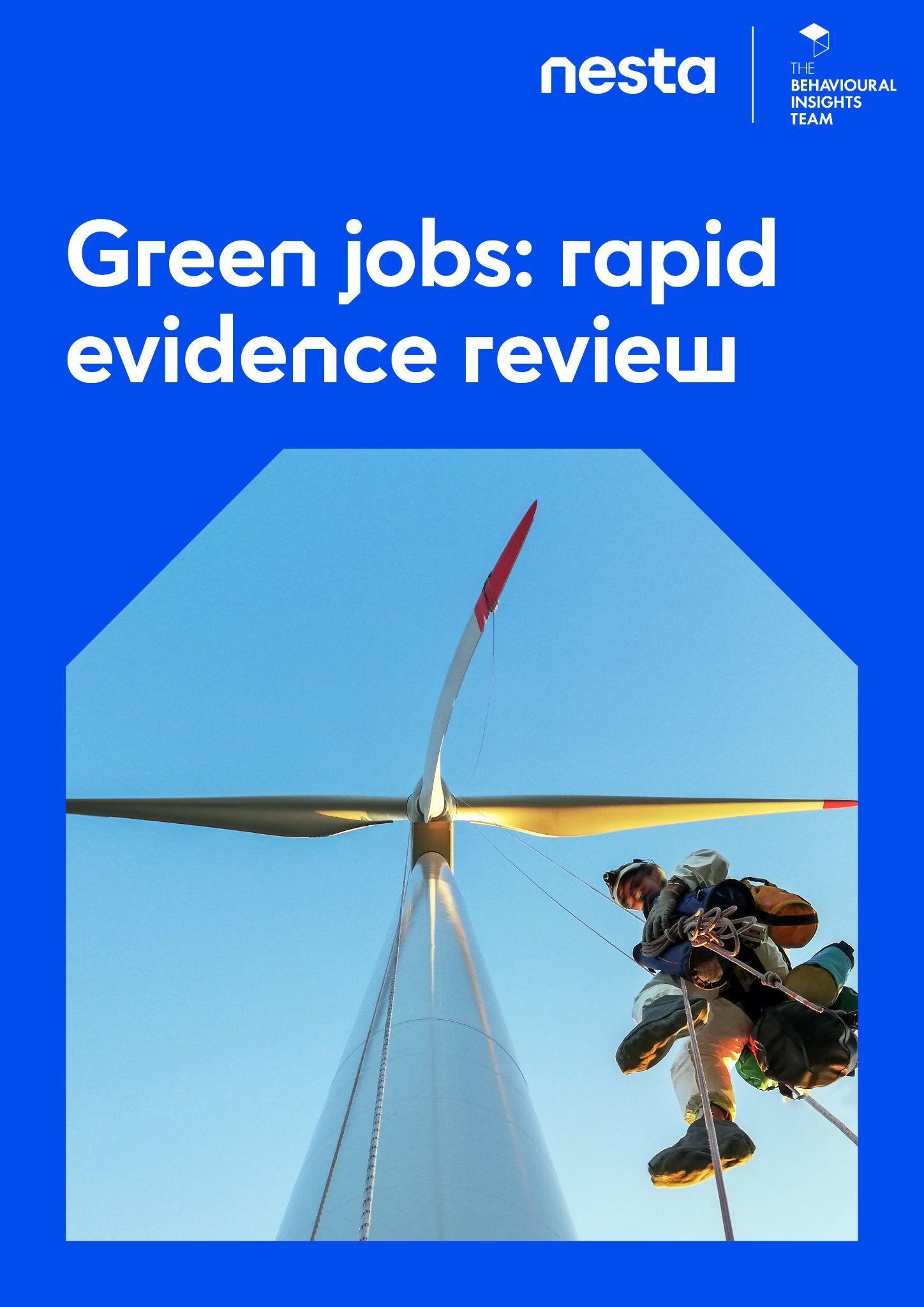 Worker suspended by ropes performing maintenance on a wind turbine, illustrating the concept of a "green job."