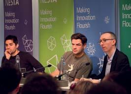 Three panelists, including two younger men and one older man in glasses, participate in a discussion at a Nesta event.
