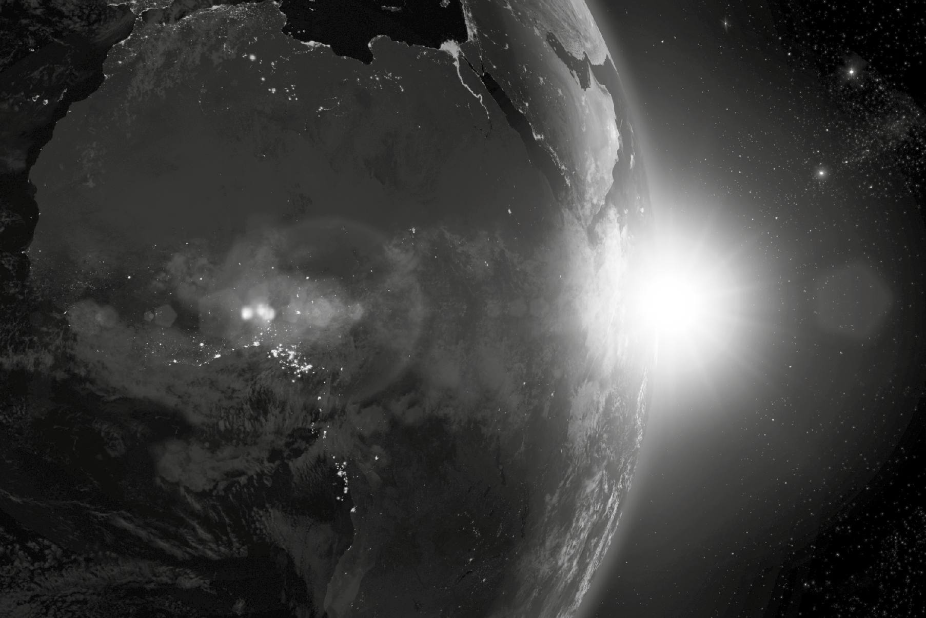 Earth from space showing city lights on the night side and sunrise over the horizon.