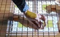 A hand interacting with a projected grid interface on small blocks, likely demonstrating data manipulation or a technological system.