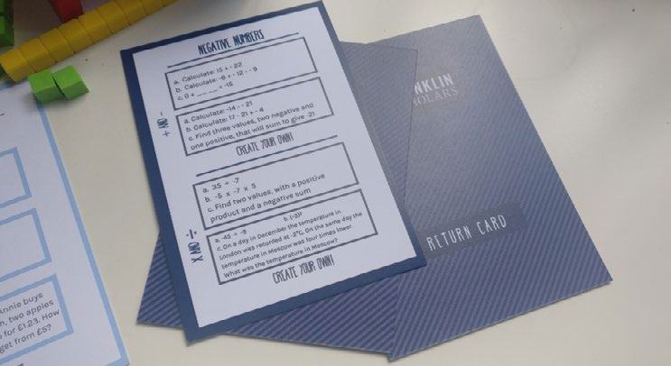 Close-up of a physical worksheet titled 'NEGATIVE NUMBERS' displaying various math problems, alongside a partially visible 'RETURN CARD'.