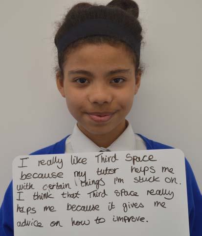 A young girl holding a whiteboard with a handwritten testimonial praising "Third Space" for tutor help and advice on improvement.