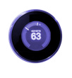 A round black smart thermostat displaying a temperature of 63 degrees.
