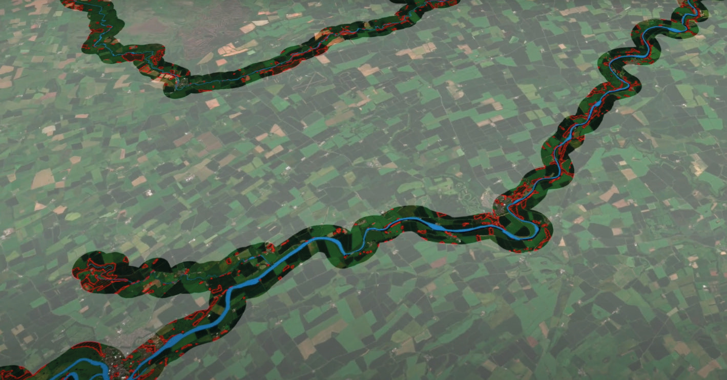 Aerial map showing a winding river (blue) through green and brown landscape with red outlined areas.