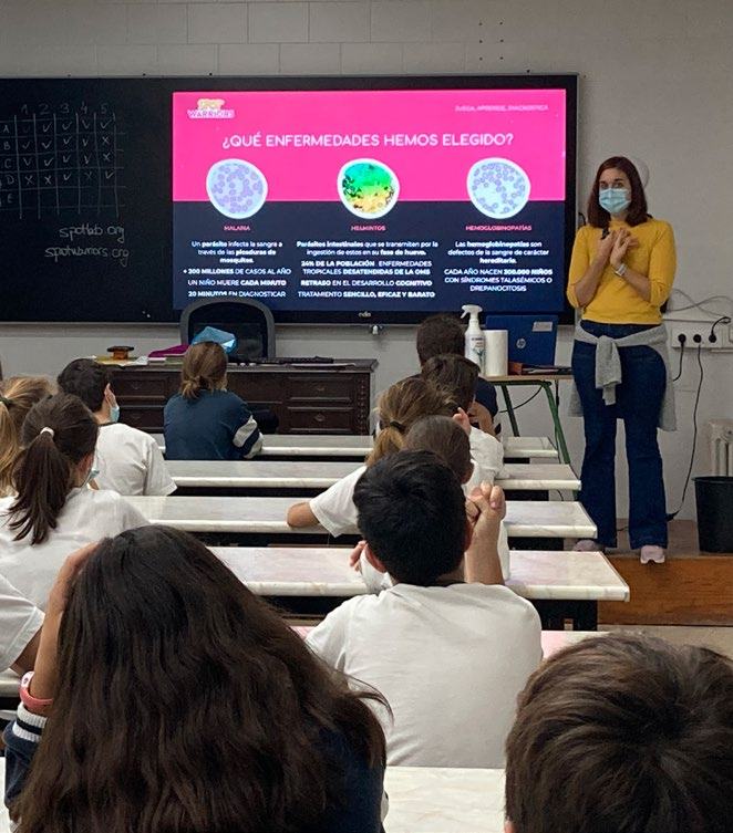 Classroom presentation slide detailing three diseases: Malaria, Helminths, and Hemoglobinopathies, with descriptions and statistics, presented to students by a teacher.