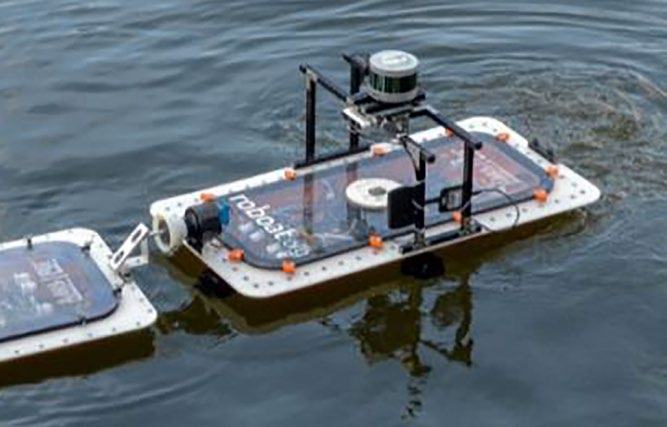 A "Roboat" modular autonomous boat platform with sensors on its surface, floating in water.