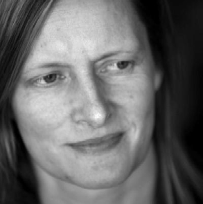 Black and white close-up portrait of a woman looking to her right.