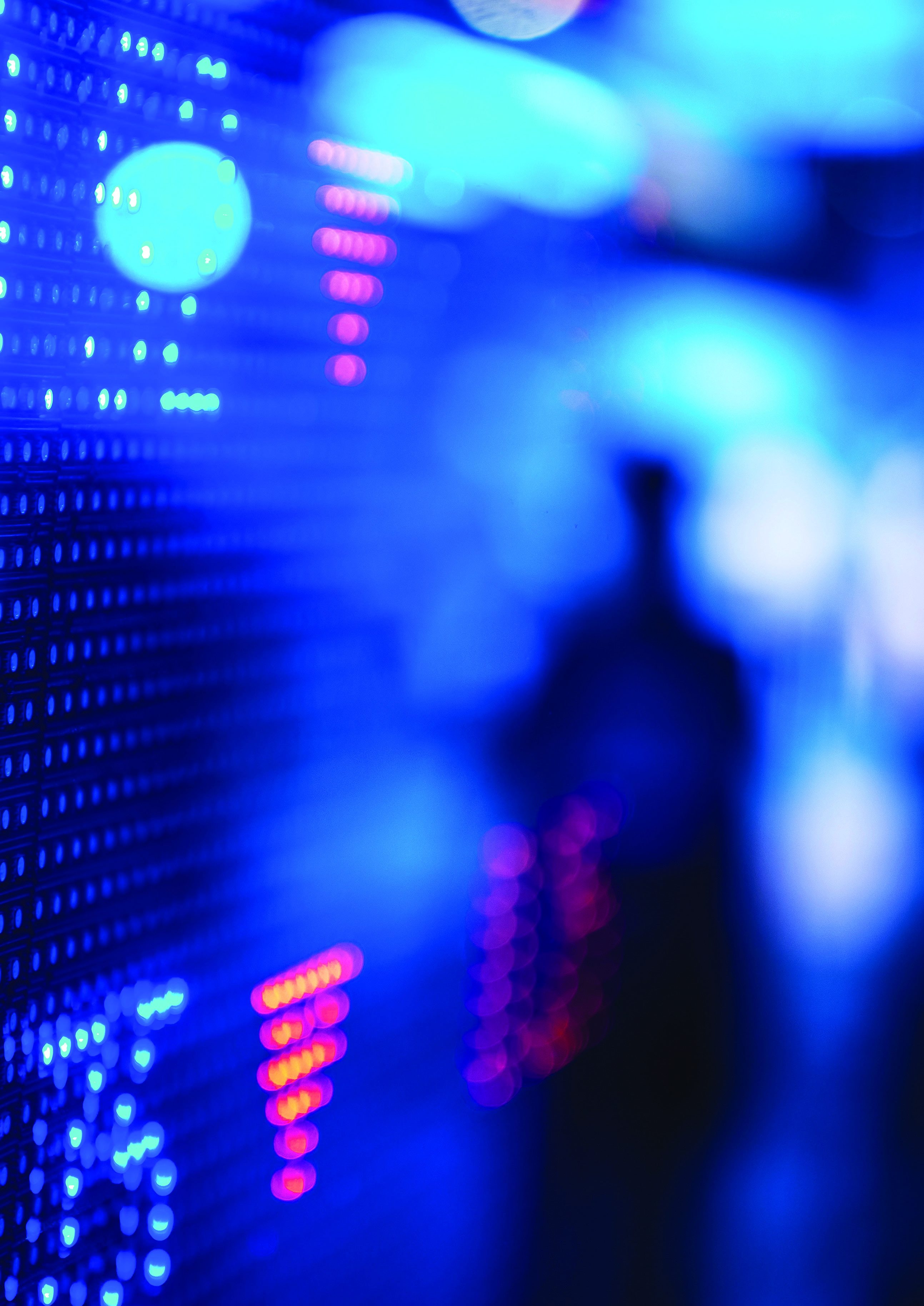 Stylized image of a blurred digital display, possibly a stock market ticker, showing red and blue lights with patterns resembling data trends or numbers, and a human silhouette.