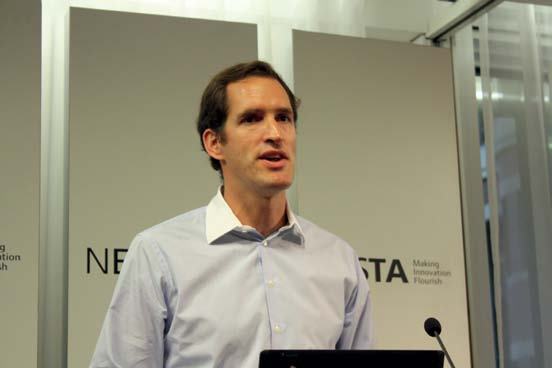 Man speaking at a Nesta event, with "Making Innovation Flourish" visible in the background.