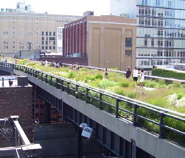 An elevated park pathway, possibly the High Line, with green landscaping and people walking. Urban buildings are in the background.