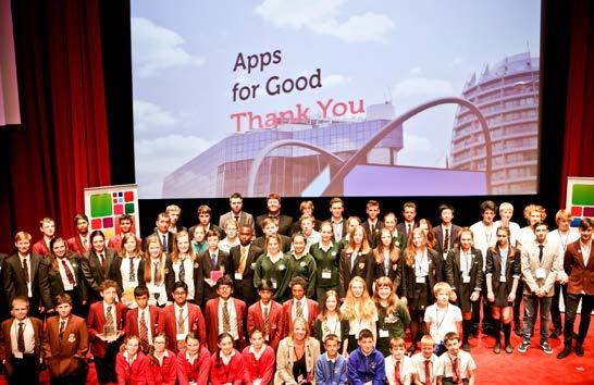 A large group of students and adults on stage at an "Apps for Good" event, with "Thank You" displayed on a screen.