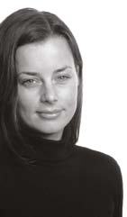 Black and white portrait of a smiling woman with dark hair.
