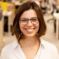 Headshot of a young woman with short brown hair and glasses, smiling.
