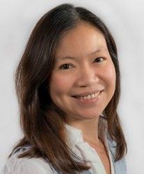 Headshot of an Asian woman with long brown hair, smiling