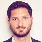 Headshot of a smiling man with a beard.