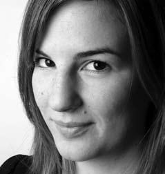 Black and white headshot of a young woman with long dark hair, smiling subtly.