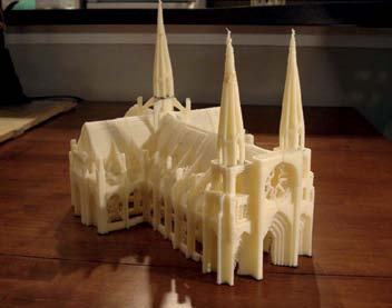 A detailed 3D printed model of a Gothic cathedral with multiple spires, viewed from an elevated angle.