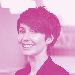 Headshot of a woman with short dark hair smiling, tinted pink.