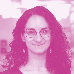 Headshot of a woman with long curly hair and glasses smiling, tinted pink.
