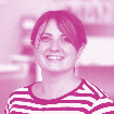 Headshot of a smiling woman with short hair, wearing a striped shirt.