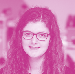 Headshot of a smiling woman with long curly dark hair and glasses.