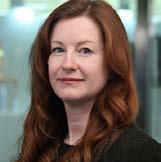 Headshot of a woman with long red hair, looking forward.