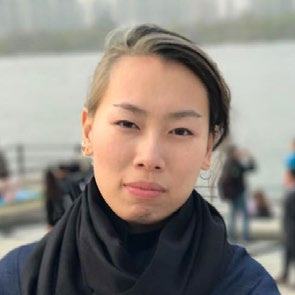 Headshot of a young East Asian woman with two-tone hair, wearing a black scarf