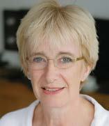 Headshot of a smiling blonde woman with glasses.