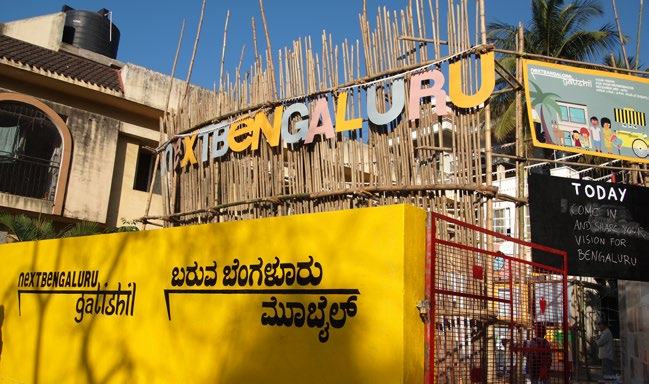 Outdoor installation for "Next Bengaluru" community project, showing event signage and a call to action to share vision.