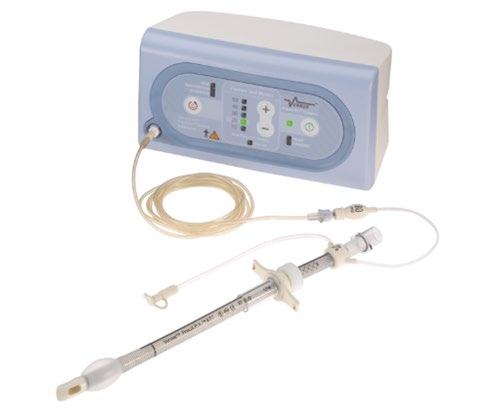 A medical device with a main unit featuring a control panel, connected via tubing to a smaller, handheld syringe-like component.