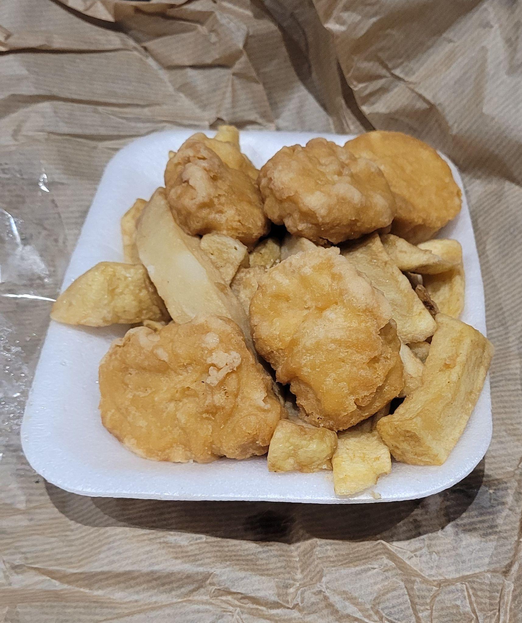 A white styrofoam container filled with chicken nuggets and chips, representing a food item analyzed in the report.