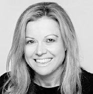 Black and white headshot of a smiling woman with long blonde hair.