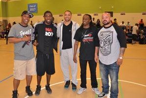 Five men pose for a photo on a basketball court, possibly a team or participants in an event.