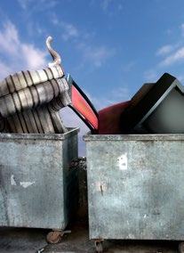 Large discarded items, including a sofa and a television, overflowing from two metal dumpsters under a blue sky.