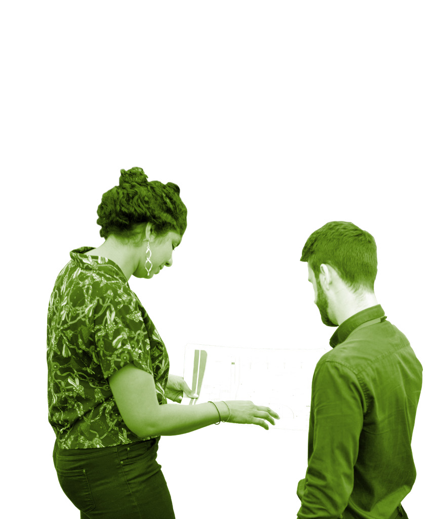Two people discussing a transparent blueprint or diagram, with one person pointing.