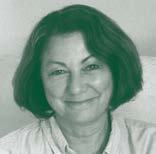 Headshot of a smiling woman with dark, wavy hair