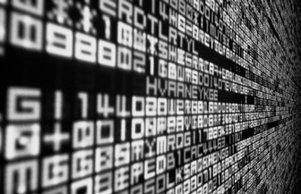 An angled view of a screen filled with a matrix of glowing alphanumeric characters and symbols, representing digital data or code.