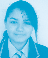 Headshot of a young woman wearing a school uniform blazer and tie.