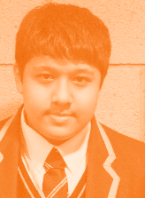 Portrait of a young male student in a school uniform, with an orange tint.